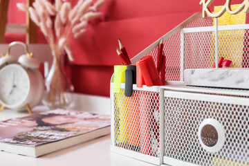 Modern organizer with stationery on table, closeup