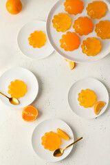 Plates with tasty orange jelly on white background - obrazy, fototapety, plakaty