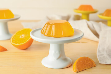 Dessert stand with tasty orange jelly on light wooden background - obrazy, fototapety, plakaty