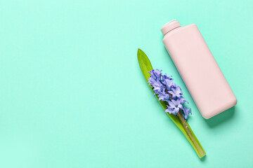 Bottle of cosmetic product and beautiful hyacinth flower on color background
