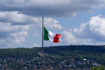 Italian flag at garden plot with City of Zurich in the background. Photo taken May 22nd, 2021, Zurich, Switzerland.