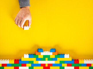 hand stacking up the plastic block