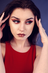 Fototapeta na wymiar beautiful woman with creative make up in red