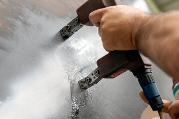 The inspector is testing with magnetic particle inspection method to welds of the pressure vessel. Magnetic particle Inspection (MPI) is a non-destructive testing (NDT) process for detecting surface.