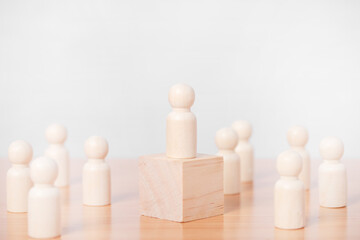 Wood person model standing on the podium among people on white background.