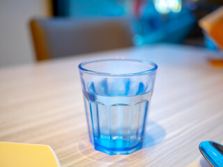 Paper towels, cutlery and glass water glasses on the dining table