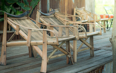 Fototapeta na wymiar Bamboo chairs in the garden a place for a relaxing break in the morning rice field.
