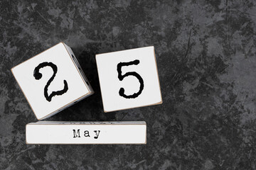 May 25th. May 25 white wooden cube calendar on grey grunge concrete background