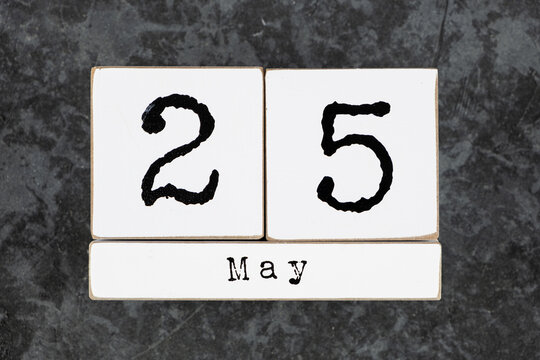 May 25th. May 25 white wooden cube calendar on grey grunge concrete background