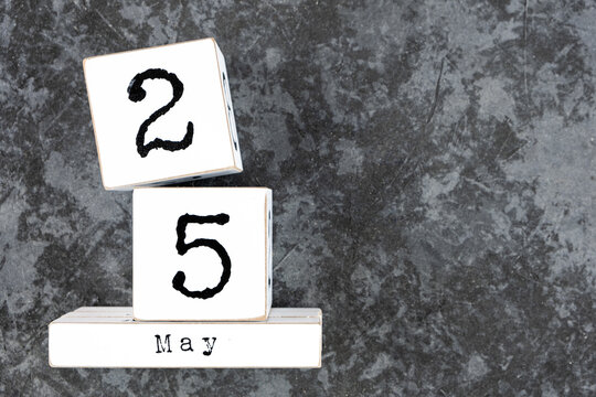 May 25th. May 25 white wooden cube calendar on grey grunge concrete background