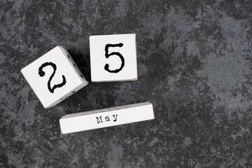 May 25th. May 25 white wooden cube calendar on grey grunge concrete background