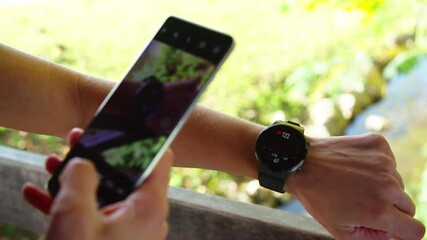 Person take photo of smartwatch jogging stats for social media 4K - Powered by Adobe