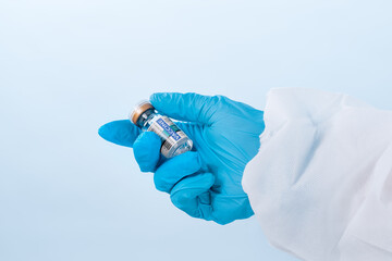 NO LOGOS OR TRADEMARKS!  SELF MADE LABELS! Close up view of doctor’s hand with an ampule of covid...