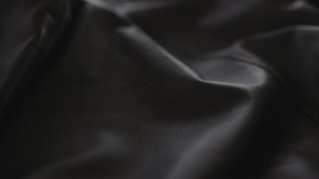 Slow motion handheld shot of soft gray leather jacket