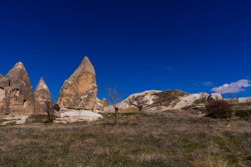 Fototapeta premium Panoramic view of fairy chimneys and typical rock formations near Göreme, Cappadocia, Turkey