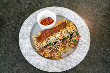 stir-fried spaghetti with garlic, olive oil, parsley, Parmigiano-Reggiano cheese tossed and bacon