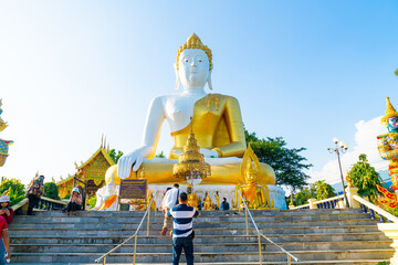 Fototapeta premium Chiang Mai, Thailand - 6 Dec 2020 : View of Wat Phra That Doi Kham (Golden Temple) at Chiang Mai, Thailand. This temple is perched on Doi Kham hill