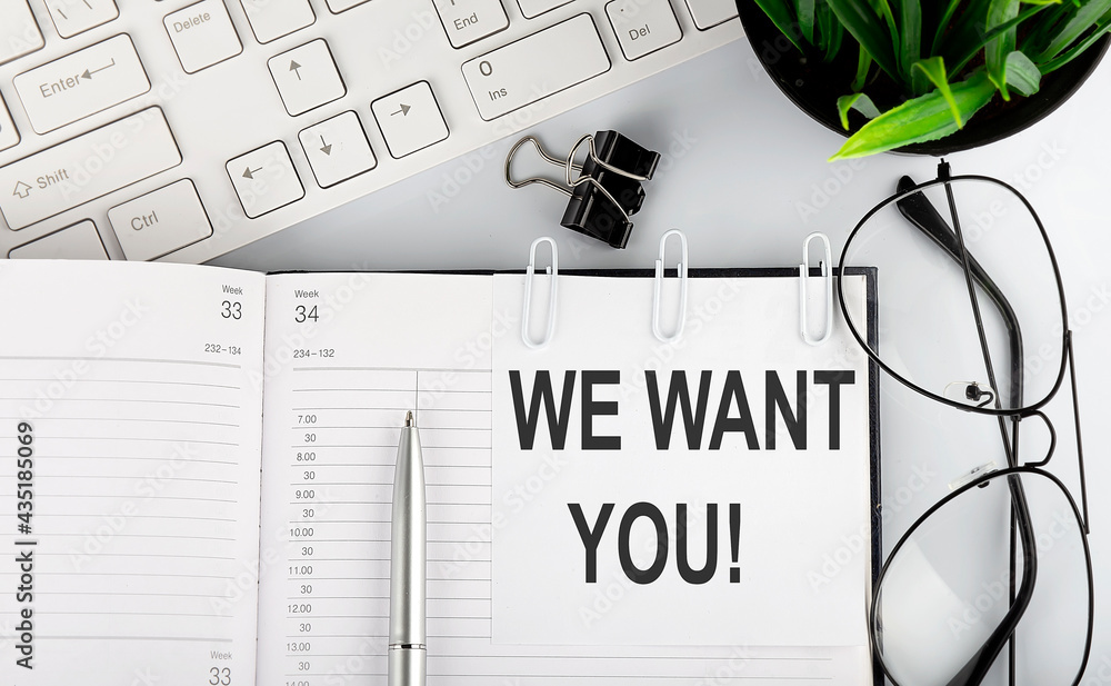 Poster text we want you on calendar planner to remind you an important appointment with a pen and keyboard 
