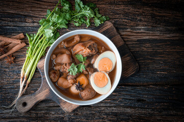 Food of thailand Pig, stewed eggs in white bowl on black background.