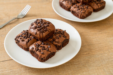 dark chocolate brownies topped by chocolate chips