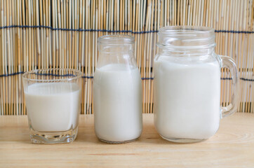 Delicious homemade soybean milk over wooden background