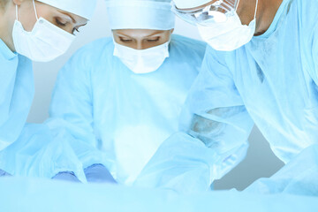 A group of surgeons is operating at the hospital. Health care concept