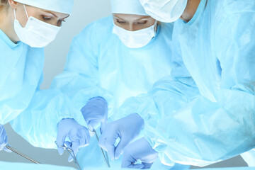 Fototapeta premium A group of surgeons is operating at the hospital. Health care concept
