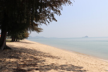 Sandy beach Bright sky Calm sea Only the wind Fresh air The environment is good and trees and there are no people. It is a destination for relaxation that requires a lot of peace. photo in Thailand.