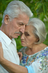 Portrait of sad senior couple in the park