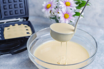 The process of making belgian waffles.