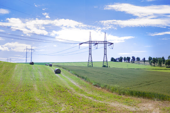 rural sun-drenched agricultural fields with haystacks in the golden hour
