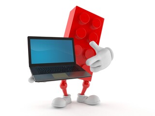 Toy block character holding laptop