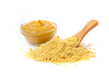 Mustard yellow sauce in a transparent bowl and powder mustard isolated on a white background.