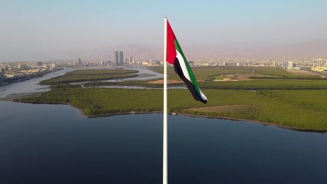 UAE flag and Ras al Khaimah emirate in the north United Arab Emirates aerial skyline landmark view