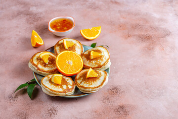 Homemade american pancakes with orange fruits.
