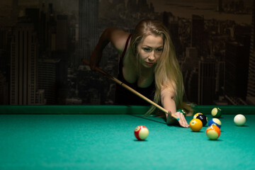 sexy girl with a cue in a billiard club