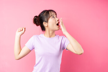 portrait of young asian girl on pink background