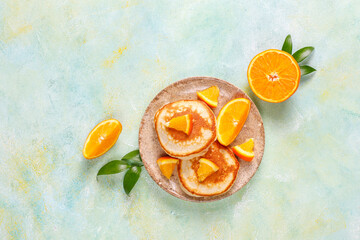 Homemade american pancakes with orange fruits.