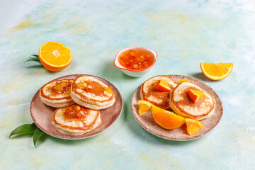 Homemade american pancakes with orange fruits.
