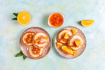 Homemade american pancakes with orange fruits.