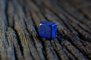 Lapis Is a beautiful natural gemstone on a wooden floor	