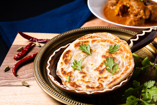 Food concept Homemade roti paratha on wooden board with copy space