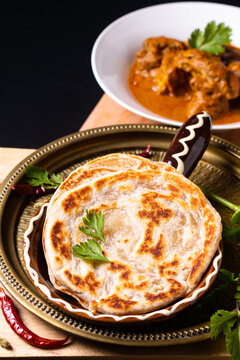 Food concept Homemade roti paratha on wooden board with copy space