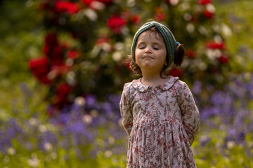little girl with closed eyes enjoys  the season in which everything grows, blooms and particularly smells amazing