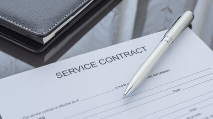 A service contract form on the desk. Agreement.
