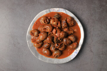 Serving of stewed snails in sauce