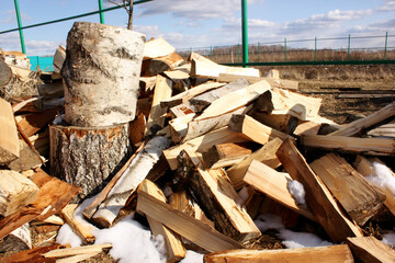 Abstract photograph of piles of natural wooden logs. Background. Harvesting firewood for the winter. Texture. Wood for the fireplace. Birch boards. Macrosymka. Copy space