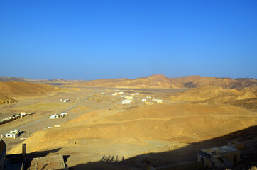 Desert. A beautiful landscape in the middle of the rocky mountains in a magnificent, beautiful landscape. Egypt. Blue sky. Copy space. Homes in the middle of the desert.