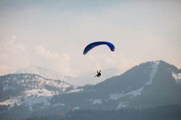 Paragliding in the mountains. The pilot flies on a paraglider upside down