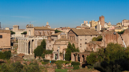 Fototapeta na wymiar Ruins of the Roman Forum. View the ruins of the ancient city against the backdrop of the Troyan market